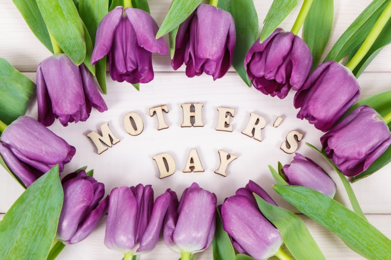 Purple tulips on a board surrounding the words mother's day.